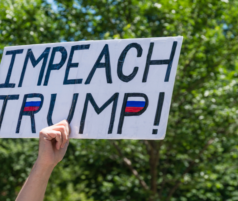 Boston, MA / USA - June 15, 2019: Crowd of citizens protest to impeach President Donald Trump at rally held in front of the state capital building in Boston.