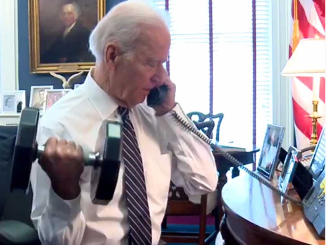 Biden on Phone in OVal Office while lifting weight