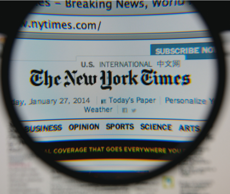 new york times through lens of magnifying glass suggesting scrutiny for media bias