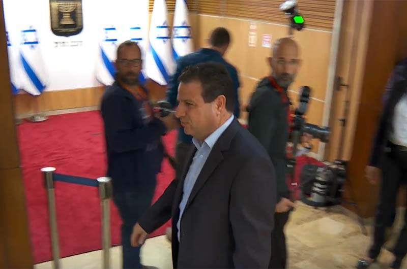 MK-Ayman-Odeh-walking-away-from-a-photo-op-with-Israeli-flags-November-15-2022